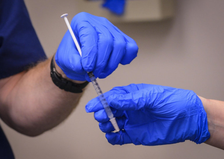 Doctors Exchanging Syringe