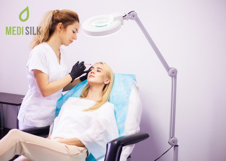 Doctor injecting patient's forehead